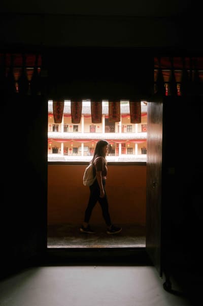 Hannah walking past an open doorway